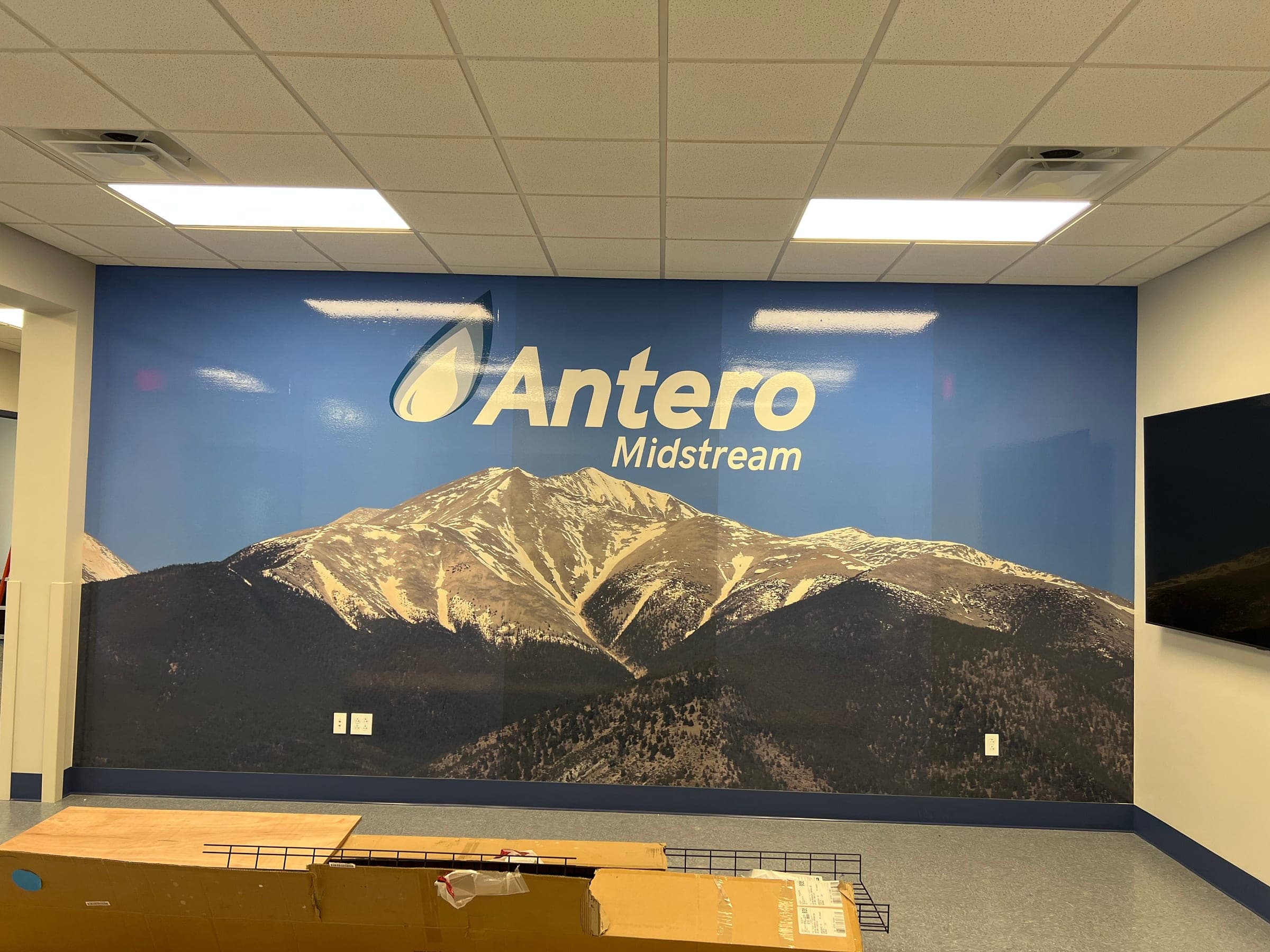 Full wall wrap of a snow-capped mountain with the Antero Midstream logo